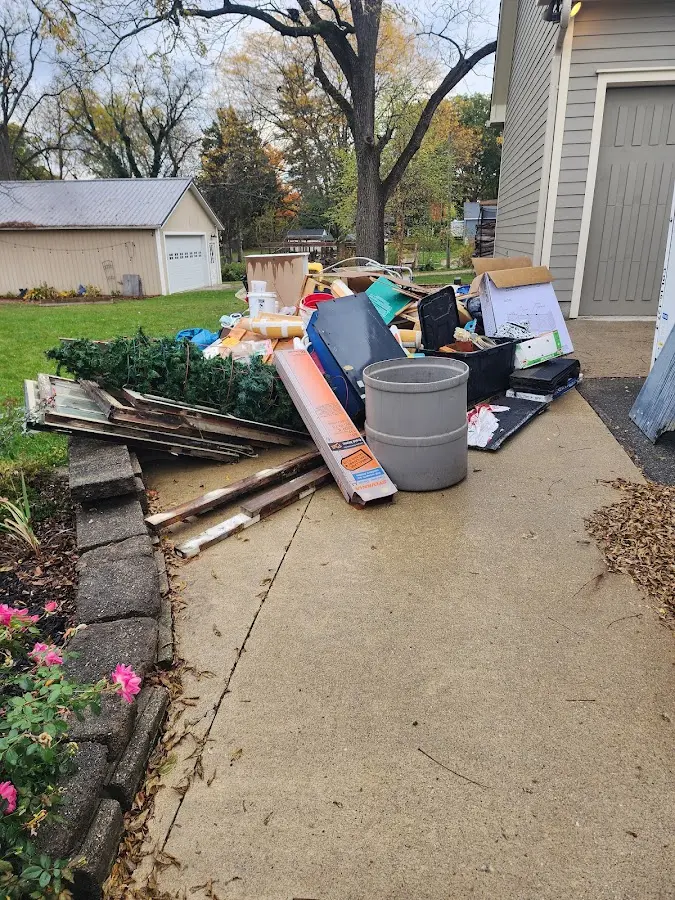 Dumpster being loaded with debris for 3 Yard Dumpster Rental in Rantoul